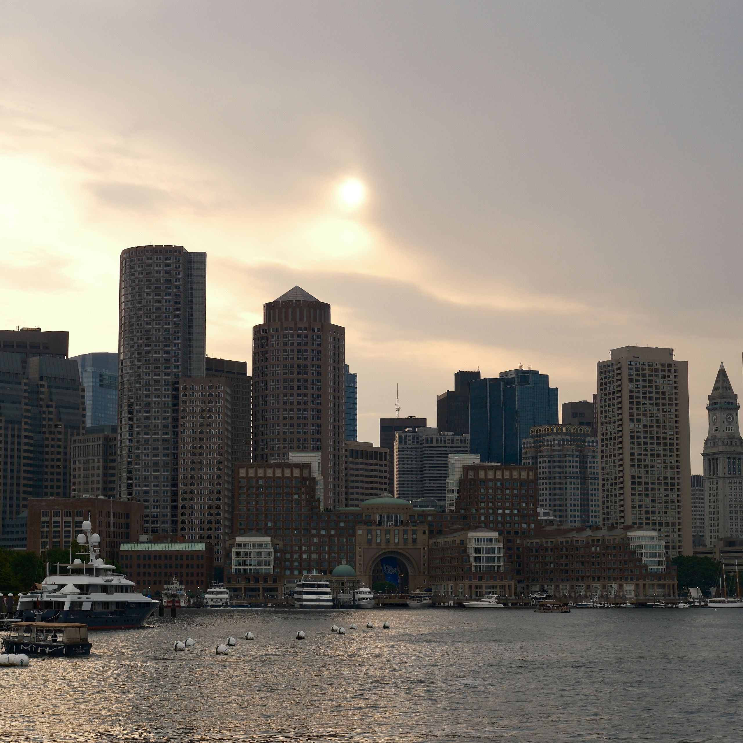 Scenic view of Boston's skyline and harbor at dusk with a calming atmosphere.